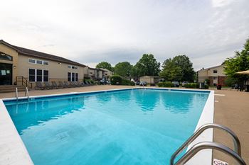 A large swimming pool with a metal ladder on the side.